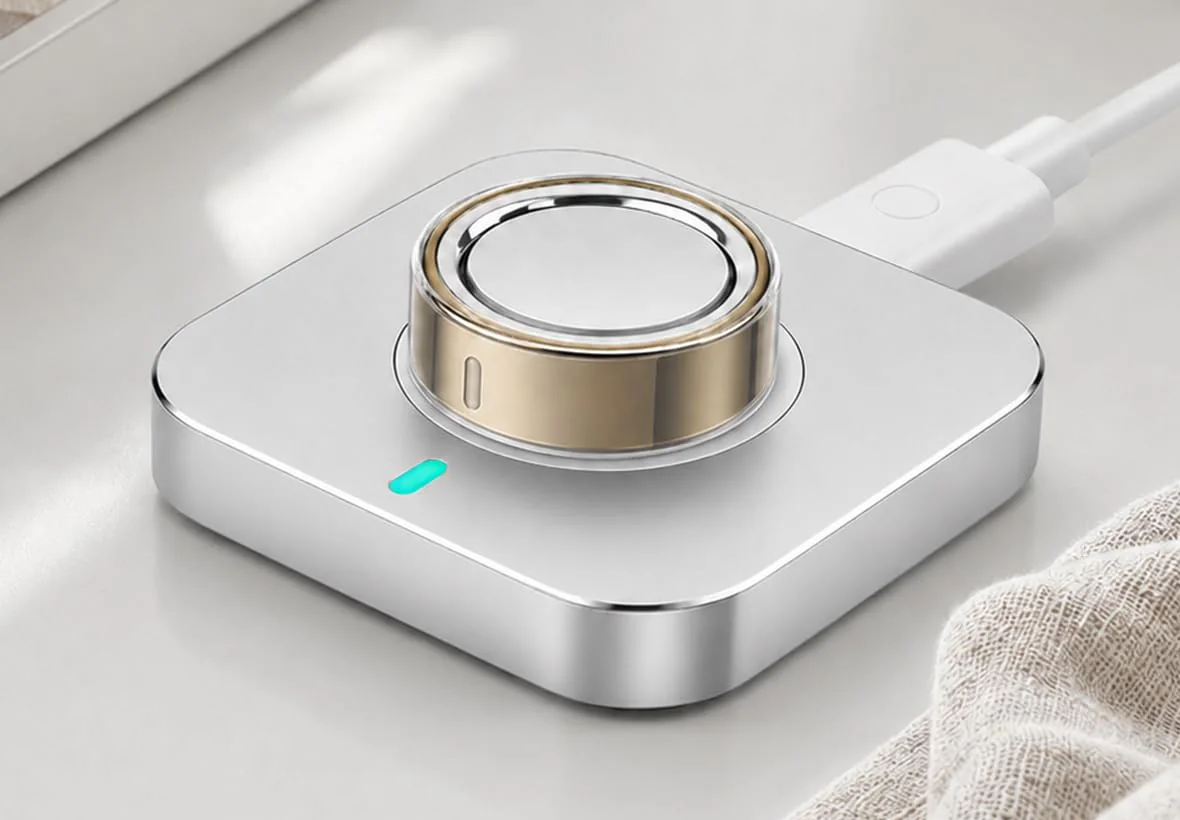 Covered gold Oura Ring 5 seated on its charger for a post-installation charging check